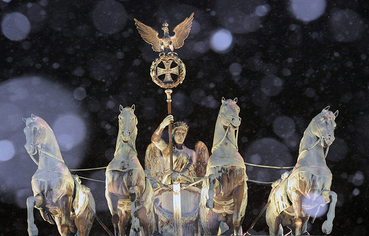 Cold weather abroad: Berlin, Germany: The Brandenburg Gate as snowflakes fall 