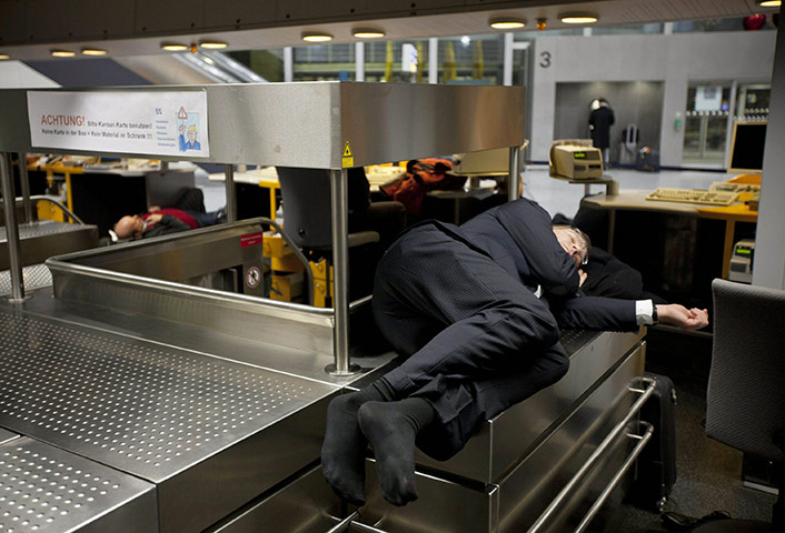 24 hours in pictures: Passengers sleep at the luggage check in, Germany