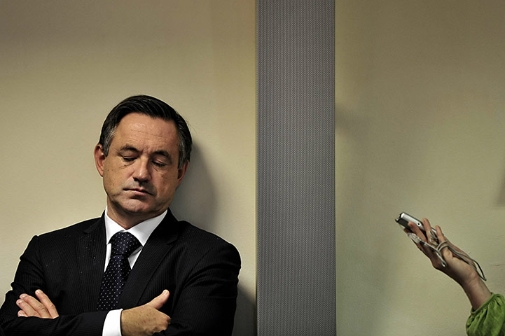 24 hours in pictures: Servaas Deroose shuts his eyes during a press conference