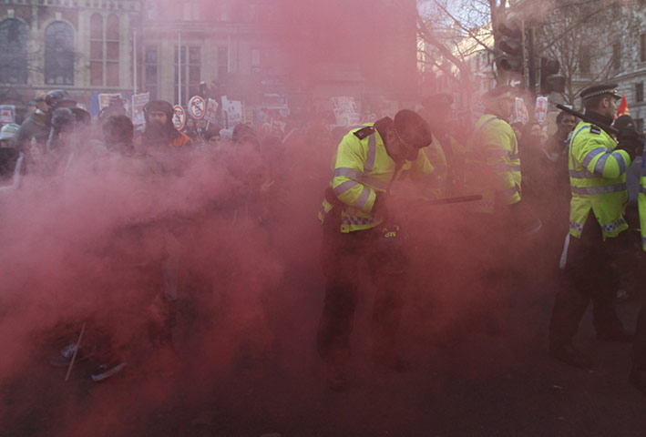 student protest update: Demonstrators and police officers surrounded by smoke in Parliament Square