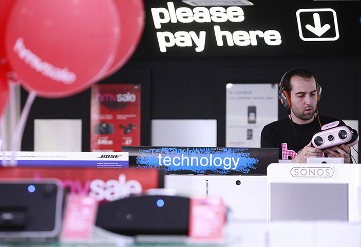 Business week in pictures: An HMV employee checks an iPod sound dock in the technology section of HMV