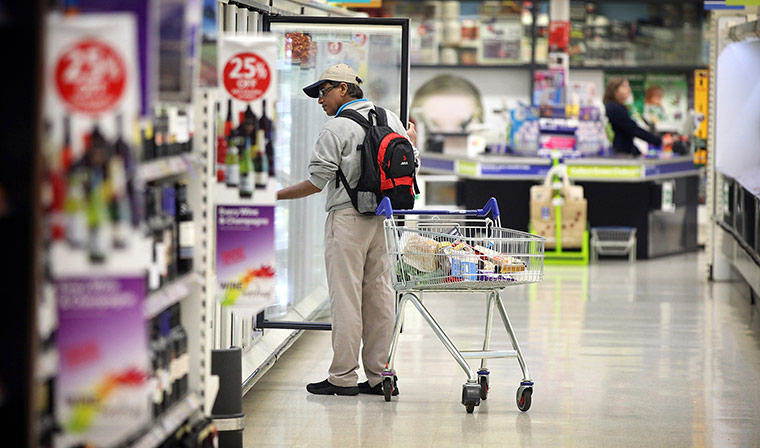 Business week in pictures: A customer browses for products at a Tesco supermarket