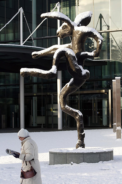 Business week in pictures: A pedestrian walks past a sculpture outside AIB bank's headquarters