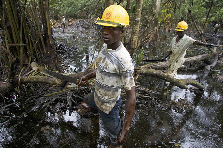 Business week in pictures: Workers subcontracted by Shell Oil Company clean up an oil spill in Nigeria