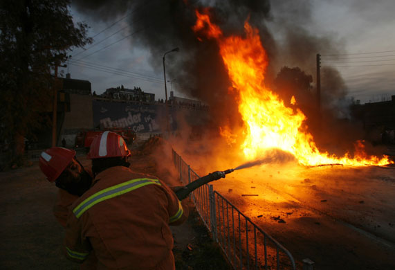 24 hours : Firefighters try to extinguish a burning oil tanker in Peshawar 