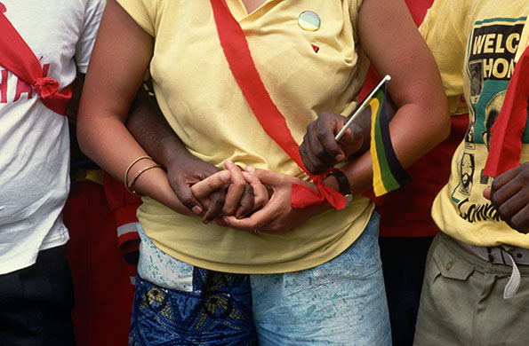 Mandela prison release: 26 February 1990: South Africans hold hands at a Durban rally