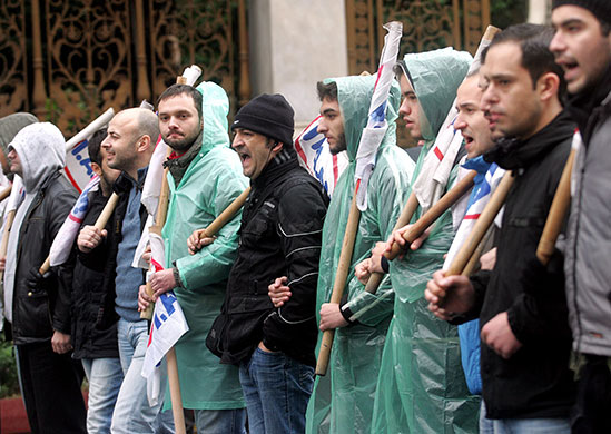 Week in Business: Demonstrators shout slogans during a public sector strike in Athens