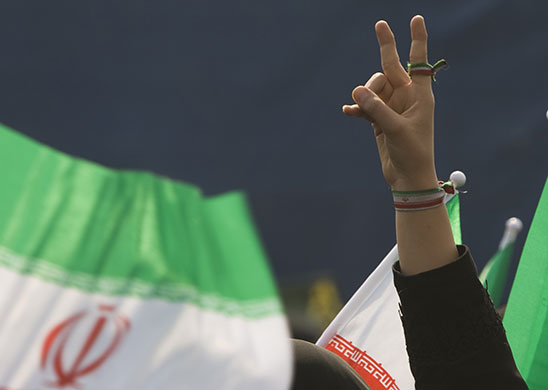 Iran 31st anniversary: An Iranian woman gestures 31st anniversary of the Islamic Revolution