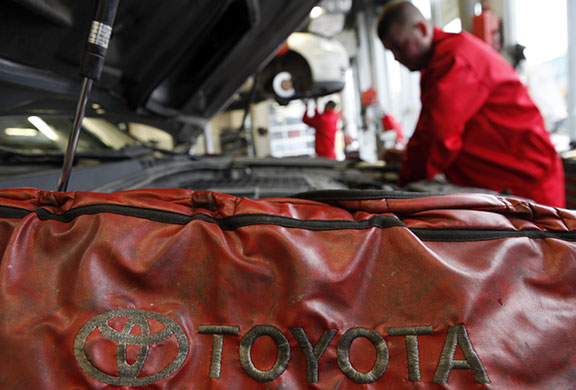 Week in Business: Mechanics repair cars at a Toyota service centre in Warsaw