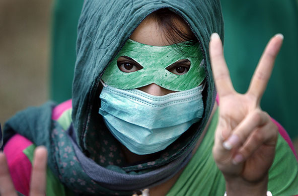 24 hours in pictures: Singapore: An Iranian student gestures during a protest