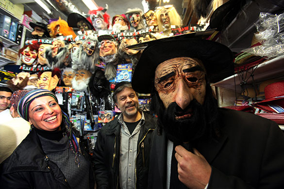 24 hours in pictures: Jerusalem: A man wears a mask at a shop