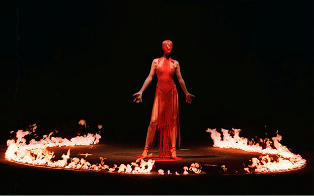 Alexander McQueen: 1998: A model stands among a ring of fire Alexander McQueen 