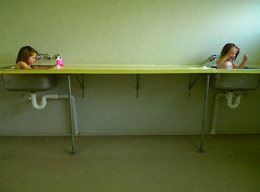 In Pictures: Clean: Reader's photo of two girls bathing in sinks.