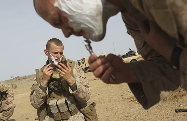 24 hours in pictures: Marjah, Afghanistan: US Marines shave after waking up at a forward camp
