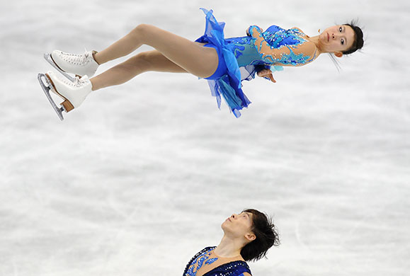 Winter Olympics Day 2: Qing Pang spins through the after being thrown by her partner Jian Tong