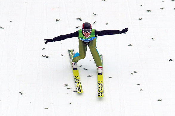 Winter Olympics Day 2: Simon Ammann celebrates as he lands and wins the men's Ski Jumping final 