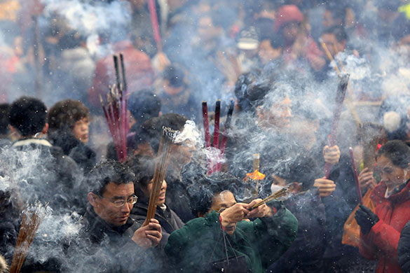 24 hours: Lanzhou, China: Worshippers pray with incense