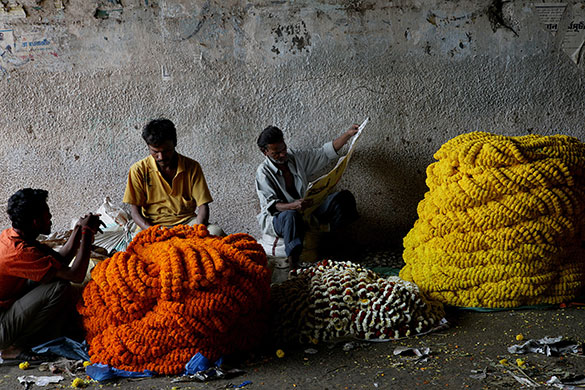 24 hours: Calcutta, India: Vendors wait for customers at Mallikghat flower market