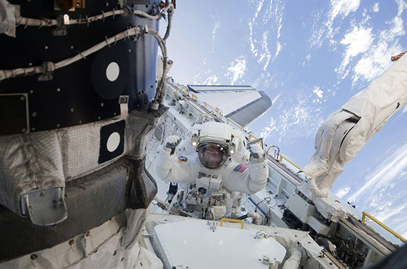 space shuttle endeavour: Nicholas Patrick works outside the International Space Station during EVA 