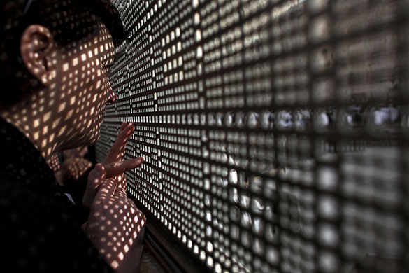 24 hours: Jerusalem: A woman looks through a fence at the Western Wall 