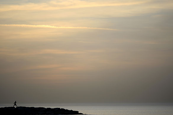 24 hours: Tel Aviv, Israel: A man walks on the coast of the Mediterranean sea 