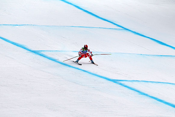 olympics day 4: Didier Defago approaches the finish line to win the men's downhill race 