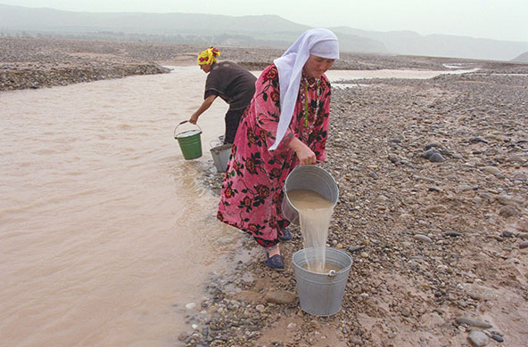 Tajikistan Climate: Bachamazor village water comittee, filling their buckets Tajikistan
