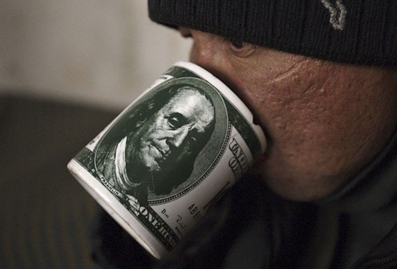 24 hours in pictures: A homeless man drinks at a municipal refuge in the city of Bishkek