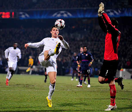 Tuesday Champions League: Cristiano Ronaldo tries to lift the ball over Lyon keeper Hugo Lloris 