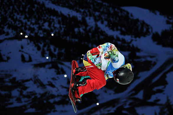 Winter Olympics day 5: A snowboarder performs during the Snowboard Halfpipe training session