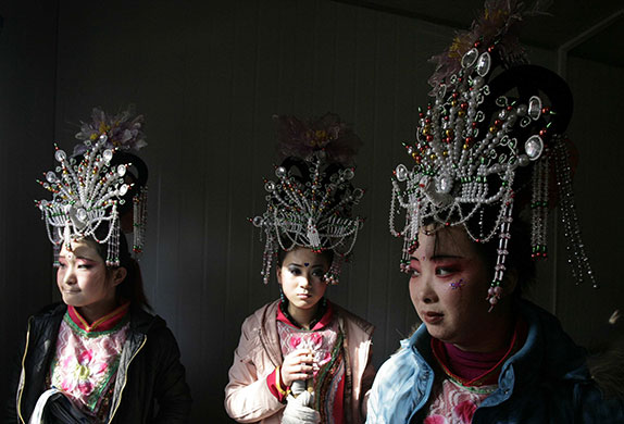 24 hours in pictures: Folk artists wait before their performance at a temple fair in Beijing