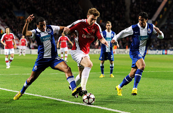 Wed Champions League: Alvaro Pereira and Bruno Alves attempt to stop Arsenal's Nicklas Bendtner 