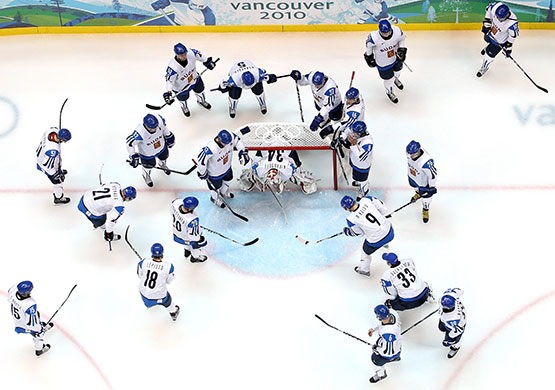 Winter Olympics day 6: Team Finland huddle around goalie Miikka Kiprusoff before taking on Belarus