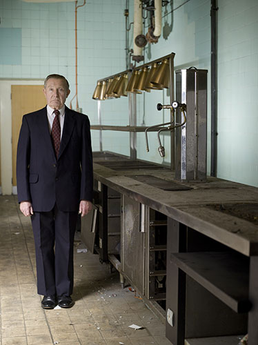 Lewis's fifth floor: Man posing in empty canteen kitchen