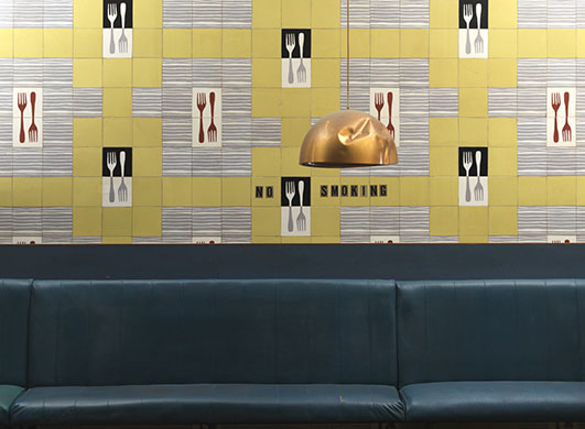 Lewis's fifth floor: Padded seating with wallpaper behind