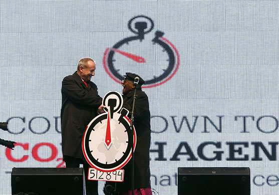 Yvo de Boer: Archbishop Tutu and Yvo de Boer on a stage in Copenhagen