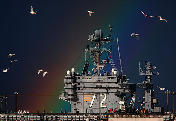 24 hours in pictures: Washington, US: Seagulls fly by the USS Abraham Lincoln with a rainbow