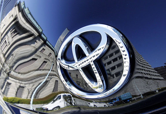 Week in business: A building is reflected in Toyota Motor Corp's Prius hybrid car in Tokyo