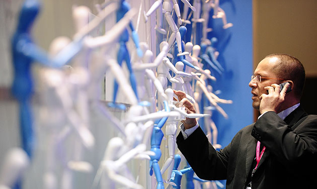Week in business: A man uses a mobile phone at the Mobile World congress