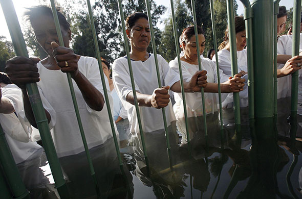 24 hours in pictures: Christian pilgrims take part in a baptism ceremony near Tiberias