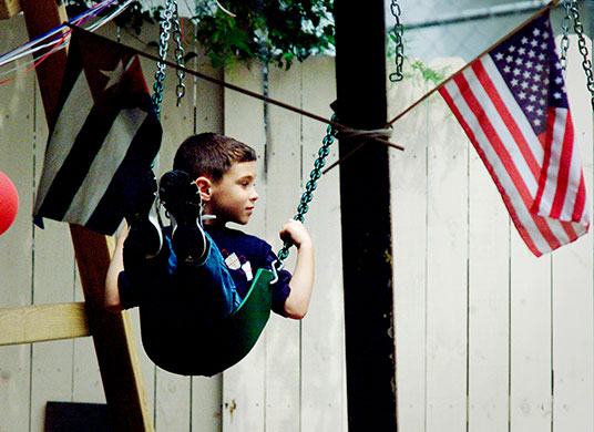 Elian Timeline: Cuban boy Elian Gonzalez swings between the Cuban and U.S. flags