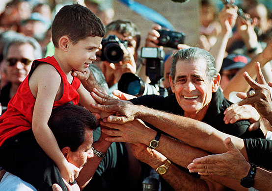 Elian Timeline: Elian Gonzalez sits on his uncle's shoulders as he is greeted in Miami