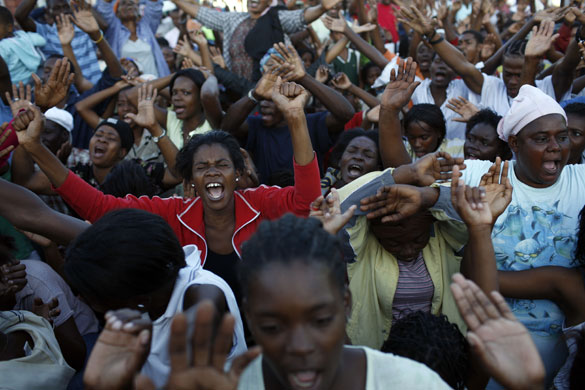 24 hours in pictures: Port-au-Prince, Haiti: People pray during a religious service