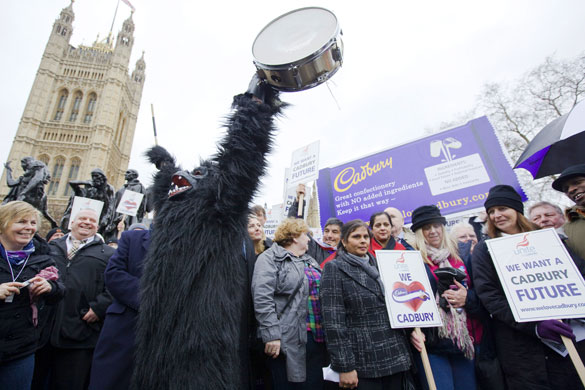 cadbury protest: A protester dressed as a gorilla bangs a drum outside parliament