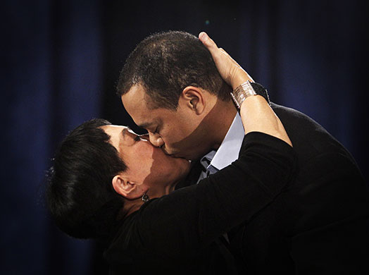 24 Hours in Pictures: Golfer Tiger Woods kisses his mother Kultida Woods after making a statement
