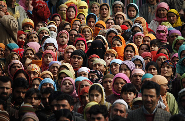 24 Hours in Pictures: Kashmiri women watch the funeral of suspected militant Sajjad Ahmed