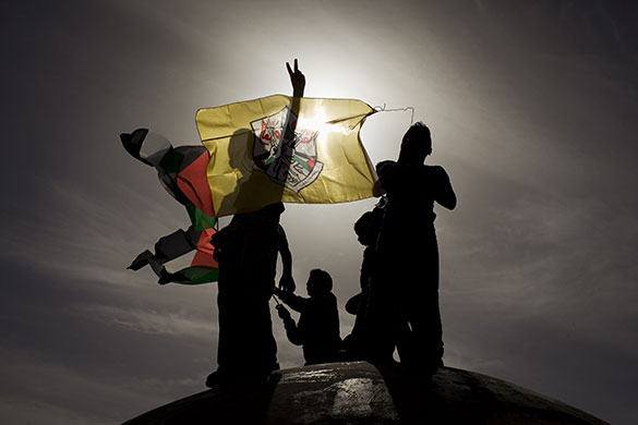 24 Hours in Pictures: Palestinian children holding Palestinian and Fatah flags during a protest