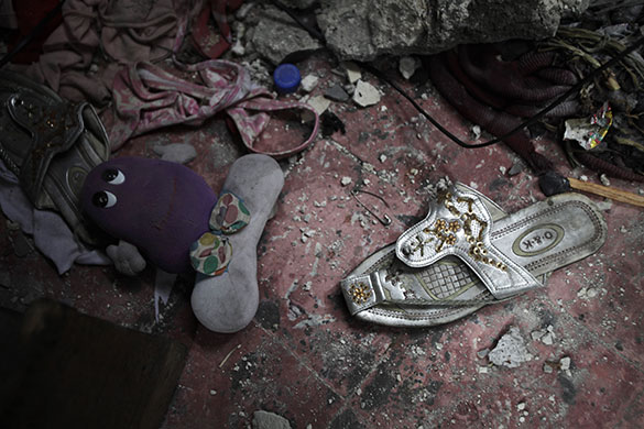 24 Hours in Pictures: A pair of silver sandals lie on the floor of an earthquake damaged home