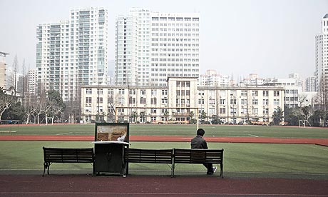 A student uses a computer on the campus of the Shanghai Jiaotong University in Shanghai