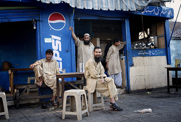 24 hours in pictures: Karachi, Pakistan: Men sit outside a tea house